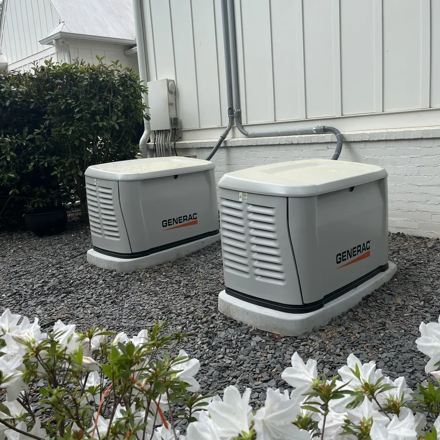 Two Generac home standby generators installed side by side at an Atlanta home